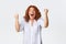 Portrait of successful winning middle-aged redhead woman celebrating victory, scream happy and amazed, fist pump