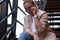 Portrait of sucessful woman on steel stairs at back yard.