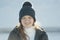 Portrait sunlit teenage girl wearing winter clothes in winter outside