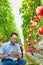 Portrait of supervisor talking using digital tablet in greenhouse