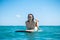 Portrait of surfer girl on surf board in blue ocean