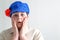 Portrait of surprised boy teenager in Russian national cap with cloves