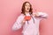 Portrait of surprised curly haired teenage girl holding sale word, opening mouth in amazement, looking shocked by discounts