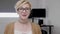 Portrait of surprised employee young woman with glasses sitting at her office -