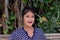 Portrait of a surprised Indian sitting on a bench in a park