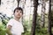 Portrait of the surprised small child in the forest seen something that surprised him. Against the background of trees