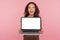 Portrait of surprised woman holding laptop with white screen copy space, mock up display for internet advertising