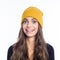 Portrait of surprised young woman wearing yellow beanie hat