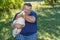 Portrait of sweet friends - cute white goose on the hands of bearded senior man