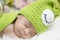 Portrait of sweet newborn baby in knitted snail costume