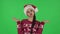 Portrait of sweety girl in Santa Claus hat is making funny faces. Green screen