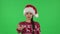 Portrait of sweety girl in Santa Claus hat is showing gesture come here. Green screen
