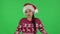 Portrait of sweety girl in Santa Claus hat upset is shrugging and sighing. Green screen