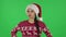 Portrait of sweety girl in Santa Claus hat is waiting and angry. Green screen