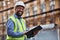 Portrait, tablet and a black man construction on a building site for planning, architecture or development. Smile