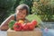 Portrait of tanned smiling little girl with fresh vegetables in