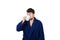 Portrait of tardy young man wears blue bathrobe holding cup of coffe unable to wake up in time to get to work, isolated on white