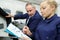 Portrait teacher and female aero engineer with clipboard