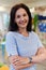 Portrait of a teacher in a preschool institution, in the background of the classrooms