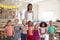 Portrait Of Teacher With Pupils In Montessori School Classroom