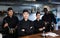 Portrait of team of cooks led by a female chef in restaurant kitchen