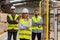 Portrait of team of warehouse employees standing in warehouse. Team of workers and female manger in modern industrial