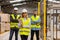 Portrait of team of warehouse employees standing in warehouse. Team of workers and female manger in modern industrial