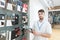 Portrait of a technology store consultant standing in a light electronics store looking at the camera