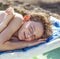 Portrait of a teen boy who lies on a sun lounger
