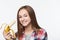 Portrait of a teen girl holding half peeled banana