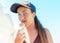 Portrait of teen girl holding and licking ice cream cone at the beach in summer vacation. Summer food, summertime joy