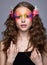 Portrait of teen girl with orchid flower in wavy hair