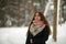 Portrait of a teen russian girl outdoors in the village at winter. Nature.