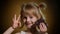 Portrait of teen smiling child kid girl with milk chocolate bar showing thumb up gesture, ok sign