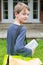 Portrait Of Teenage Boy Delivering Newspaper To House