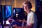 Portrait Of Teenage Boy Wearing Headset Gaming At Home Using Dual Computer Screens