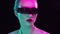 Portrait of teenage girl in cyberpunk style. Young woman posing in futuristic sunglasses. Creative studio light.