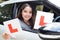 Portrait Of Teenage Girl Passing Driving Exam Holding Learner Pl