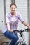 Portrait Of Teenage Girl Riding Bike In Urban Setting