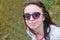 Portrait of teenage girl in sunglasses closeup on nature background.