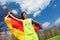 Portrait of teenage sportsman waving German flag