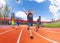 Portrait of teenage sprinter crossing finish line