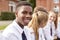 Portrait Of Teenage Students In Uniform Outside School Buildings