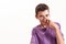 Portrait of teenaged disabled boy with cerebral palsy smiling at camera, adjusting his glasses isolated over white