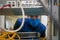 Portrait of a teenager in a data center. A technician in a medical mask works in a rack with computer equipment. The man serves