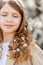 Portrait of a teenager girl with spring flowers in curly hair, soft focused, mental wellbeing, serenity and relax concept