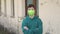 Portrait of a teenager in a green protective medical mask KN95