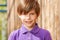 Portrait of ten years old boy in purple polo shirt