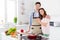 Portrait of tender gentle romantic spouses enjoy cooking weekend day prepare frying pan meat beef dinner hug embrace in