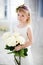 Portrait of a tender little girl with white roses